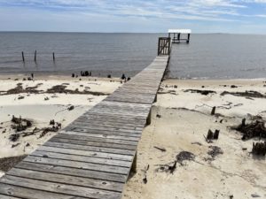 A home right on the sand with a pier and boat house.  Yes, you can actually own the sand