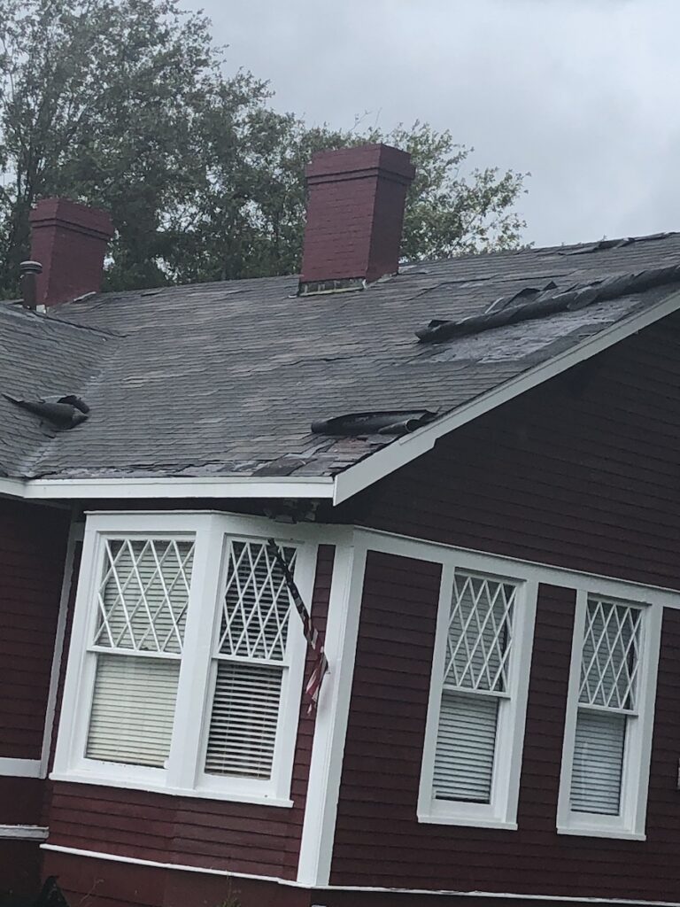 house with roof damage live in wind area replace old roof