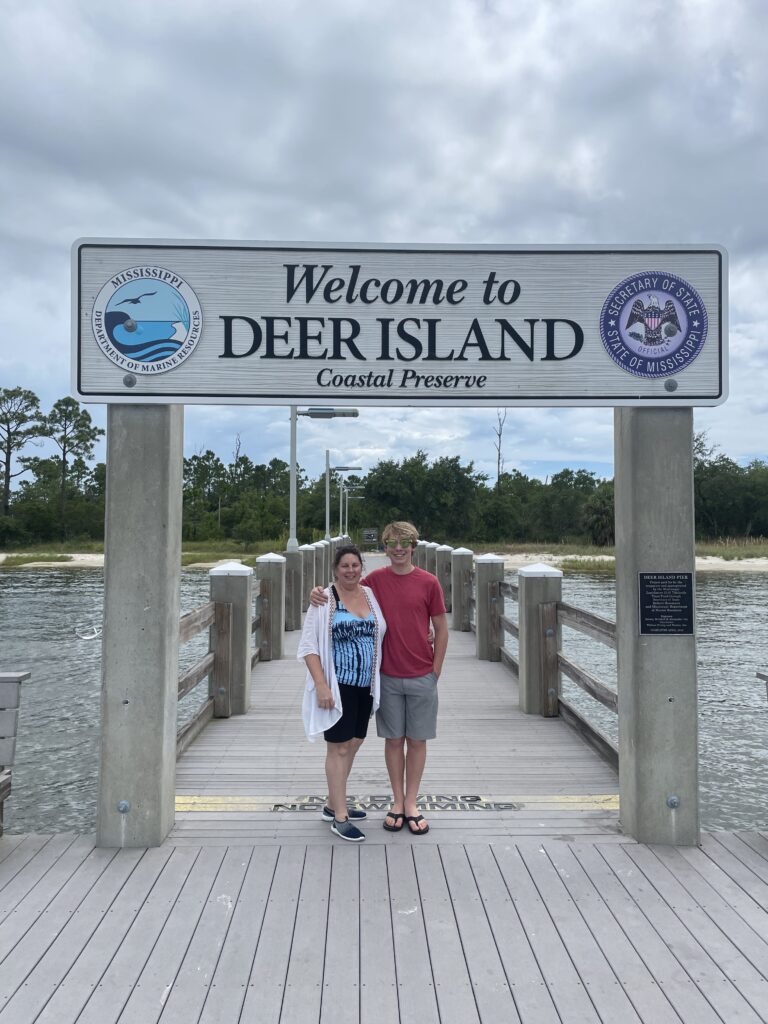 deer island sign with people