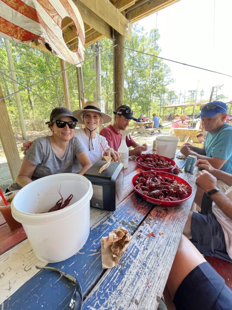 friends gathering at restaurant for a crawfish boil
