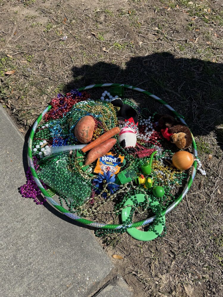 Parade participant holding St Patricks Day beads Ocean Springs