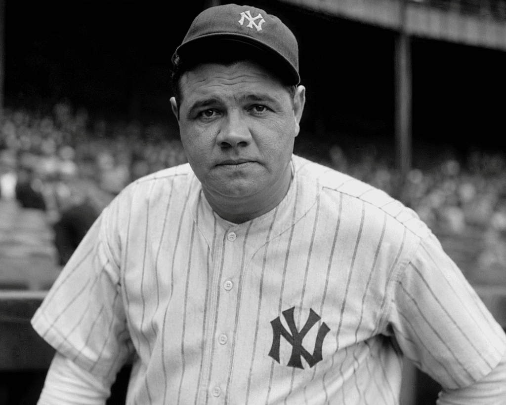 Vintage-style portrait of Babe Ruth in a New York Yankees uniform during the early twentieth century. Ruth, one of baseball's greatest players, grew up in a German-American neighborhood in Baltimore and became known as the "Sultan of Swat" for revolutionizing the game through his record-breaking home run hitting.