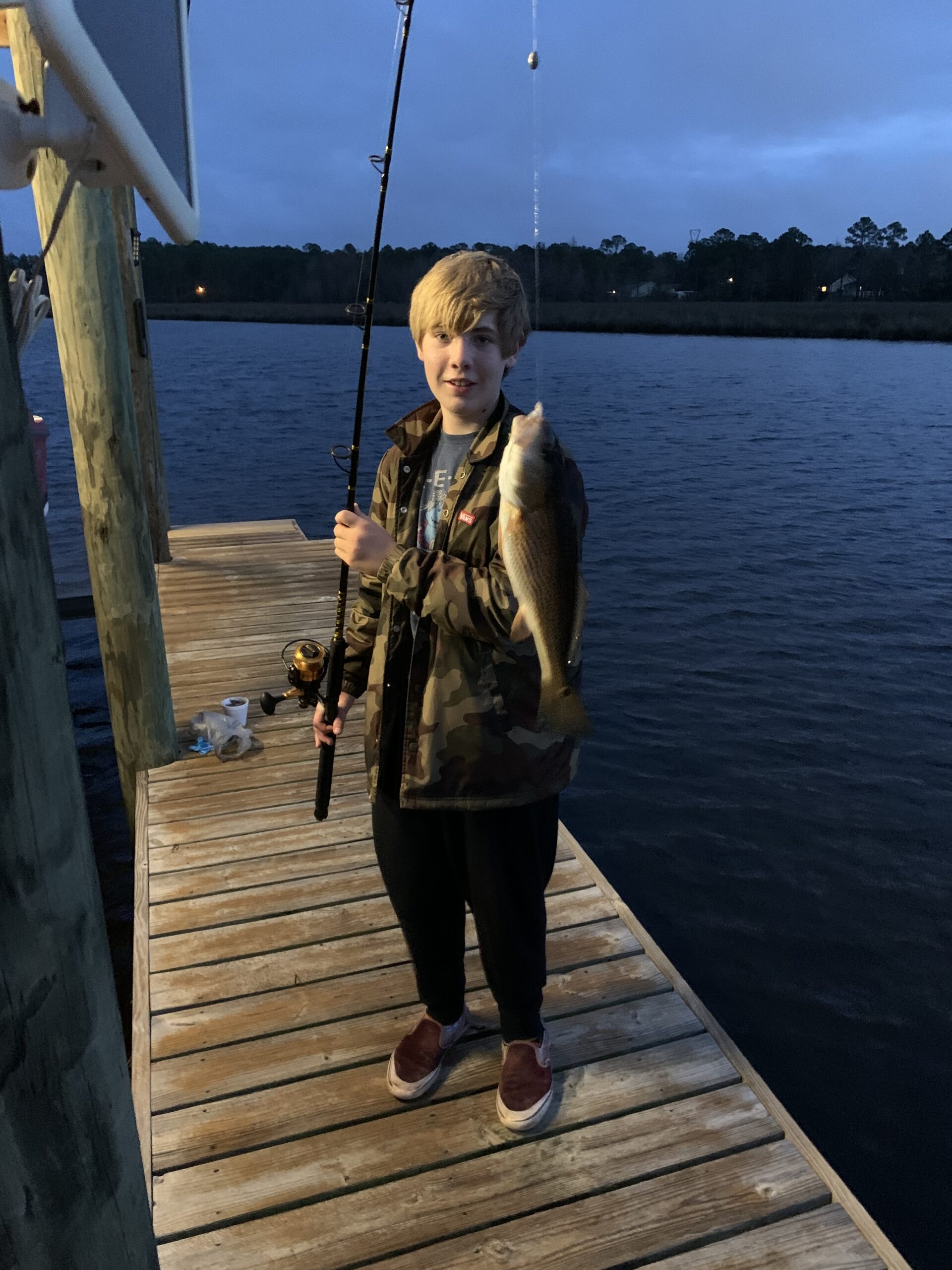 My grandson displays a saltwater fish caught during a night fishing trip from our private pier on the Mississippi Gulf Coast.